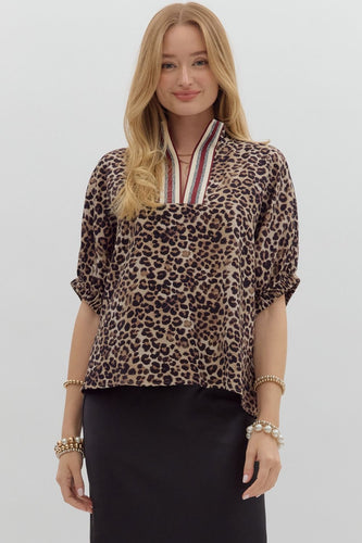 Leopard print high neck elasticated sleeve band dolman top featuring accented multicolor rib band split neck. Unlined. Woven. Non-sheer. Lightweight.