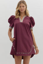 Solid pleated short puff sleeve mini dress featuring animal pattern contrast detail. Side Pockets. Lined. Woven. Non-sheer. Lightweight.