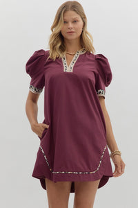 Solid pleated short puff sleeve mini dress featuring animal pattern contrast detail. Side Pockets. Lined. Woven. Non-sheer. Lightweight.