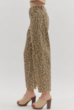 Leopard pattern ankle-length pants. Button fly-front zipper closure. Pockets at sides and back patch pockets. Unlined. Woven. Non-sheer. Lightweight.