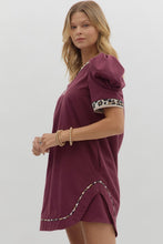 Solid pleated short puff sleeve mini dress featuring animal pattern contrast detail. Side Pockets. Lined. Woven. Non-sheer. Lightweight.