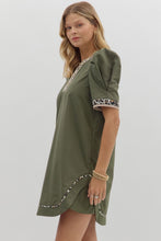 Solid pleated short puff sleeve mini dress featuring animal pattern contrast detail. Side Pockets. Lined. Woven. Non-sheer. Lightweight.
