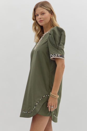 Solid pleated short puff sleeve mini dress featuring animal pattern contrast detail. Side Pockets. Lined. Woven. Non-sheer. Lightweight.