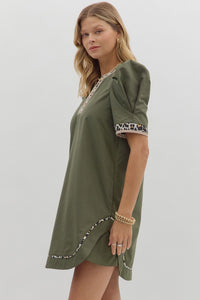 Solid pleated short puff sleeve mini dress featuring animal pattern contrast detail. Side Pockets. Lined. Woven. Non-sheer. Lightweight.