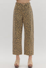 Leopard pattern ankle-length pants. Button fly-front zipper closure. Pockets at sides and back patch pockets. Unlined. Woven. Non-sheer. Lightweight.