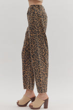 Leopard pattern ankle-length pants. Button fly-front zipper closure. Pockets at sides and back patch pockets. Unlined. Woven. Non-sheer. Lightweight.