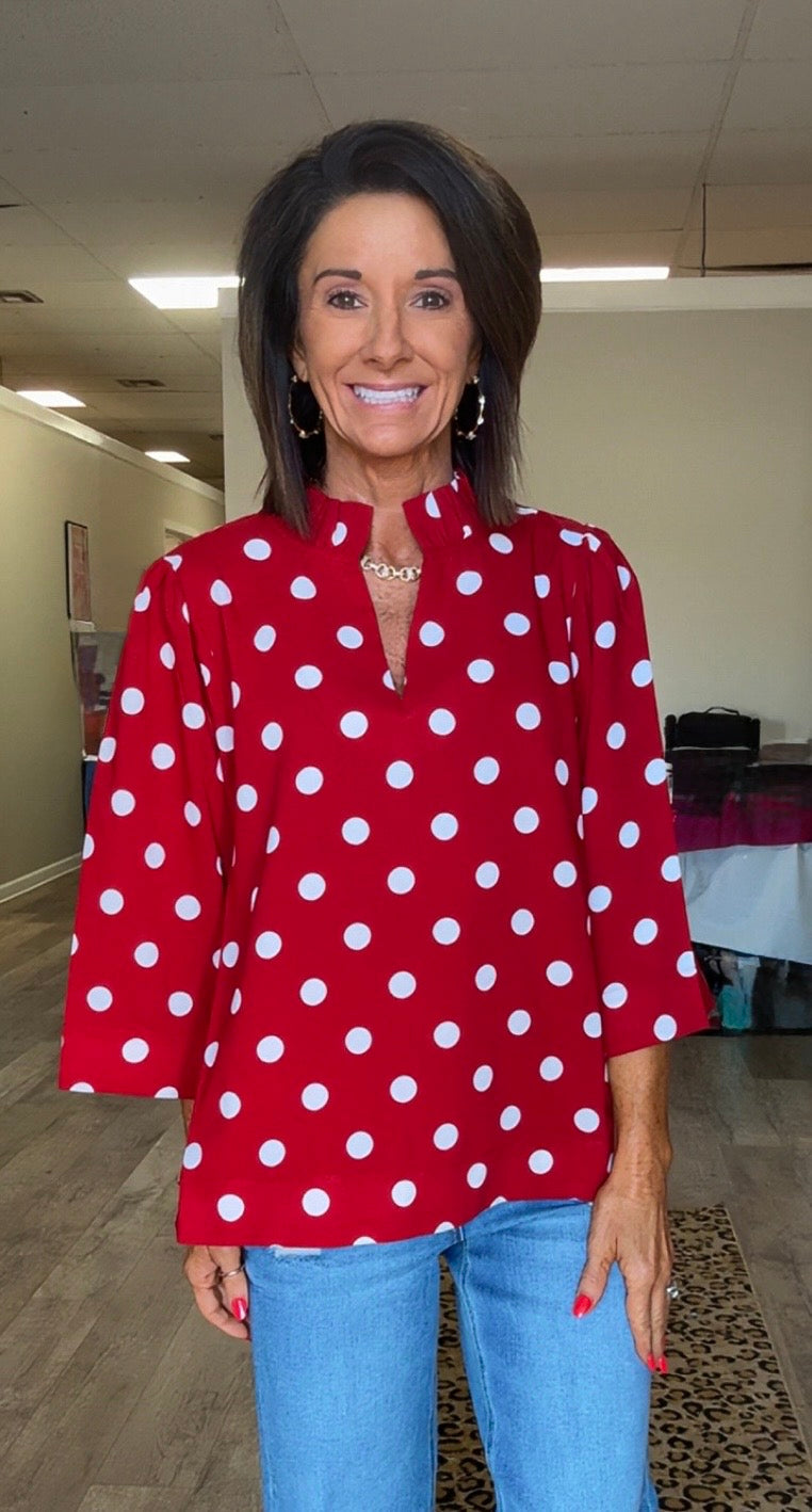 Red top. White polka dots v-neck Ruffled Neckline Polka Dot top