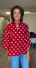Red top. White polka dots v-neck Ruffled Neckline Polka Dot top