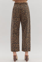 Leopard pattern ankle-length pants. Button fly-front zipper closure. Pockets at sides and back patch pockets. Unlined. Woven. Non-sheer. Lightweight.