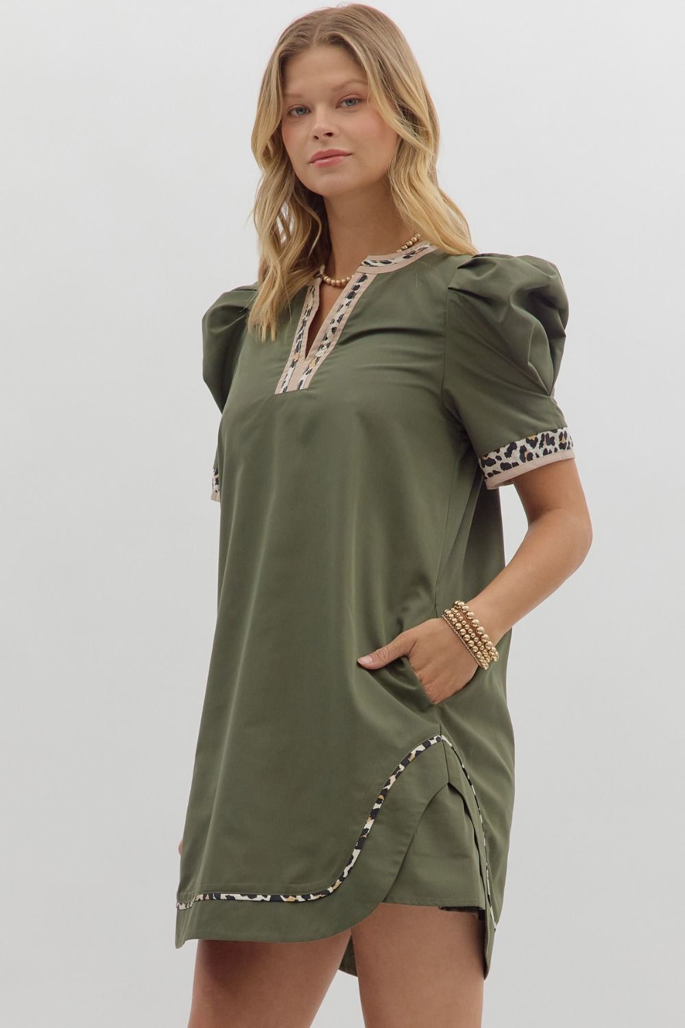 Solid pleated short puff sleeve mini dress featuring animal pattern contrast detail. Side Pockets. Lined. Woven. Non-sheer. Lightweight.