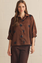Brown -Polka dot collared 3/4 sleeve top featuring button closure at front. Button cuffs. Back pleat detail. Unlined. Woven. Non-sheer. Lightweight.