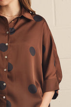 Brown -Polka dot collared 3/4 sleeve top featuring button closure at front. Button cuffs. Back pleat detail. Unlined. Woven. Non-sheer. Lightweight.