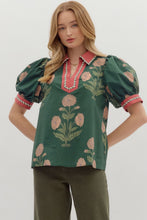 Hunter green Floral print short bubble sleeve top featuring contrast V-neck collar and band with binding inset detail. Unlined. Woven. Non-sheer. Lightweight.