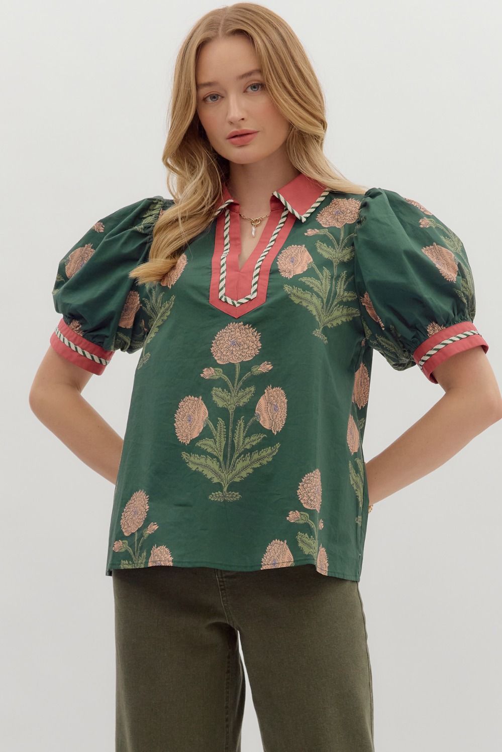 Hunter green Floral print short bubble sleeve top featuring contrast V-neck collar and band with binding inset detail. Unlined. Woven. Non-sheer. Lightweight.