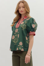 Hunter green Floral print short bubble sleeve top featuring contrast V-neck collar and band with binding inset detail. Unlined. Woven. Non-sheer. Lightweight.