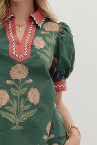 Hunter green Floral print short bubble sleeve top featuring contrast V-neck collar and band with binding inset detail. Unlined. Woven. Non-sheer. Lightweight.