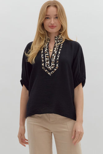 Black Solid elasticated sleeve band dolman top featuring leopard print accented caftan-inspired split neck placket. Unlined. Woven. Non-sheer. Lightweight.