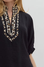 Black Solid elasticated sleeve band dolman top featuring leopard print accented caftan-inspired split neck placket. Unlined. Woven. Non-sheer. Lightweight.