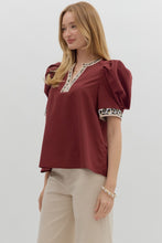 Solid pleated short voluminous sleeve pullover top featuring accent V-neck band. Unlined. Woven. LIghtweight.