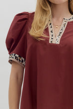 Solid pleated short voluminous sleeve pullover top featuring accent V-neck band. Unlined. Woven. LIghtweight.