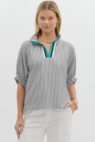 Stripe pattern high neck elasticated sleeve band dolman top featuring accented multicolor rib band split neck. Unlined. Woven. Non-sheer. Lightweight.