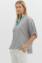 Stripe pattern high neck elasticated sleeve band dolman top featuring accented multicolor rib band split neck. Unlined. Woven. Non-sheer. Lightweight.