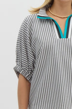 Stripe pattern high neck elasticated sleeve band dolman top featuring accented multicolor rib band split neck. Unlined. Woven. Non-sheer. Lightweight.