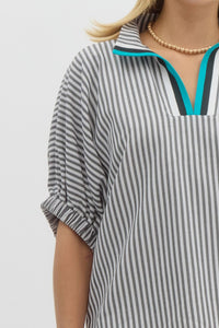Stripe pattern high neck elasticated sleeve band dolman top featuring accented multicolor rib band split neck. Unlined. Woven. Non-sheer. Lightweight.