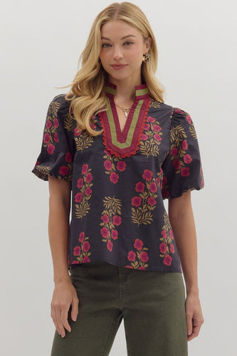 Black Floral print short bubble sleeve top featuring multicolor accent V-neck band collar. Unlined. Woven. Non-sheer. Lightweight.