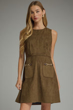 Solid sleeveless dress featuring front pockets with metal chain accent trim. Back zipper. Unlined. Woven. Non-sheer. Lightweight.