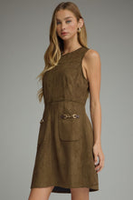 Solid sleeveless dress featuring front pockets with metal chain accent trim. Back zipper. Unlined. Woven. Non-sheer. Lightweight.