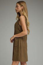 Solid sleeveless dress featuring front pockets with metal chain accent trim. Back zipper. Unlined. Woven. Non-sheer. Lightweight.