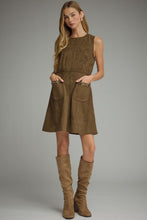 Solid sleeveless dress featuring front pockets with metal chain accent trim. Back zipper. Unlined. Woven. Non-sheer. Lightweight.