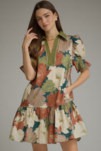 Teal Floral short puff sleeve dress with a V-neck and contrast trim detail. Smocked cuffs. Side pockets. Ruffle hem. Lined. Woven. Non-sheer. Lightweight.