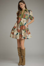 Teal Floral short puff sleeve dress with a V-neck and contrast trim detail. Smocked cuffs. Side pockets. Ruffle hem. Lined. Woven. Non-sheer. Lightweight.
