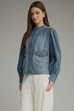 Denim Solid long puff sleeve  with button closure at front. Front patch pockets with metal hardware detail. Button cuffs. Medium weight. Jacket