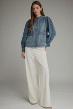 Denim Solid long puff sleeve  with button closure at front. Front patch pockets with metal hardware detail. Button cuffs. Medium weight. Jacket