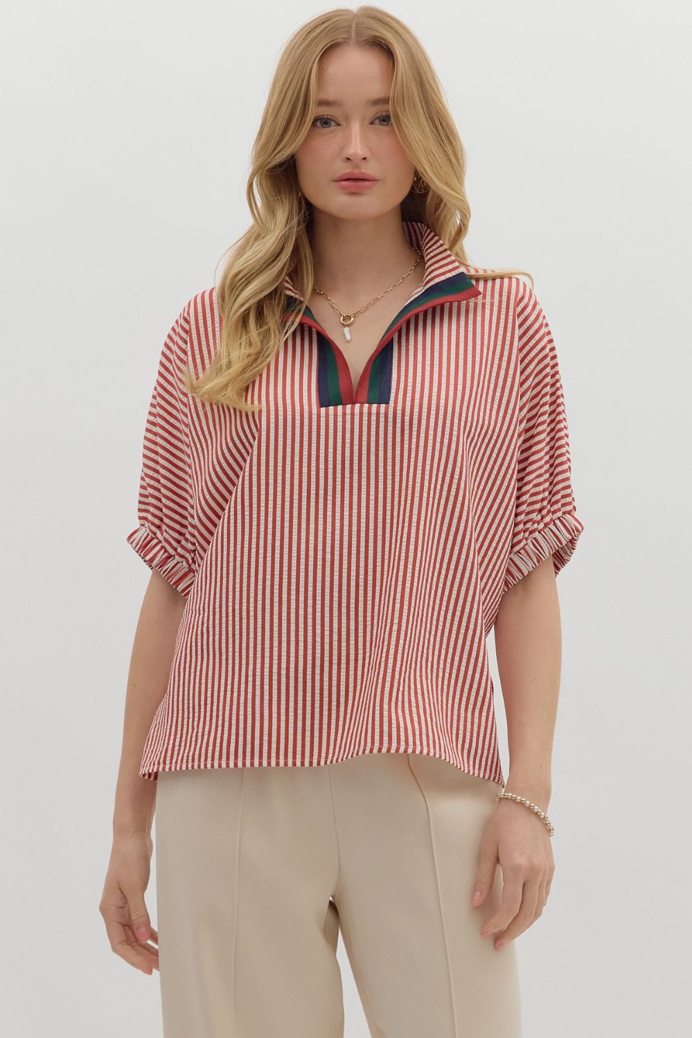 Stripe pattern high neck elasticated sleeve band dolman top featuring accented multicolor rib band split neck. Unlined. Woven. Non-sheer. Lightweight.