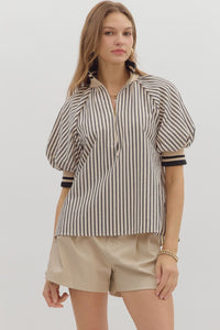 Black Stripe pattern half-zip closure short puff sleeve top featuring multicolor accent band. Unlined. Woven. Non-sheer. Lightweight.