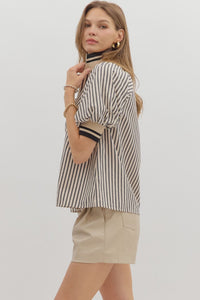 Black Stripe pattern half-zip closure short puff sleeve top featuring multicolor accent band. Unlined. Woven. Non-sheer. Lightweight.