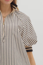 Black Stripe pattern half-zip closure short puff sleeve top featuring multicolor accent band. Unlined. Woven. Non-sheer. Lightweight.