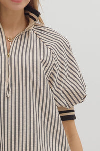 Black Stripe pattern half-zip closure short puff sleeve top featuring multicolor accent band. Unlined. Woven. Non-sheer. Lightweight.