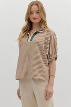 Caramel Stripe pattern high neck elasticated sleeve band dolman top featuring accented multicolor rib band split neck. Unlined. Woven. Non-sheer. Lightweight.