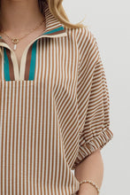 Caramel Stripe pattern high neck elasticated sleeve band dolman top featuring accented multicolor rib band split neck. Unlined. Woven. Non-sheer. Lightweight.