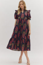 Black Floral print short puff sleeve midi dress featuring elasticized ruffle cuffs, ruffled trim split neckline, and shoulder ruffle accents. Ruffle hem. Side pockets. Lined. Woven. Non-sheer. Lightweight.