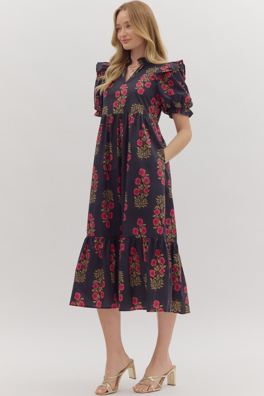 Black Floral print short puff sleeve midi dress featuring elasticized ruffle cuffs, ruffled trim split neckline, and shoulder ruffle accents. Ruffle hem. Side pockets. Lined. Woven. Non-sheer. Lightweight.