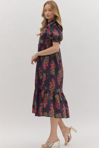 Black Floral print short puff sleeve midi dress featuring elasticized ruffle cuffs, ruffled trim split neckline, and shoulder ruffle accents. Ruffle hem. Side pockets. Lined. Woven. Non-sheer. Lightweight.