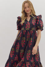 Black Floral print short puff sleeve midi dress featuring elasticized ruffle cuffs, ruffled trim split neckline, and shoulder ruffle accents. Ruffle hem. Side pockets. Lined. Woven. Non-sheer. Lightweight.