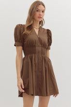 Brown Solid short puff sleeve V-neck mini dress featuring smocked waist front-zip closure. Pockets at sides. Lined. Woven. Non-sheer. Lightweight.