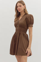 Brown Solid short puff sleeve V-neck mini dress featuring smocked waist front-zip closure. Pockets at sides. Lined. Woven. Non-sheer. Lightweight.
